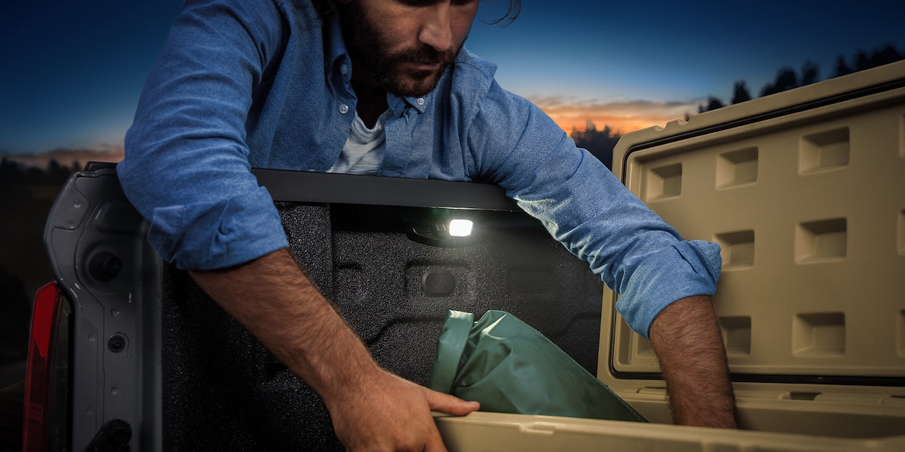 A Colorado Owner Uses the Built-In Tail Gate Lights to Look Through his Cargo at Night