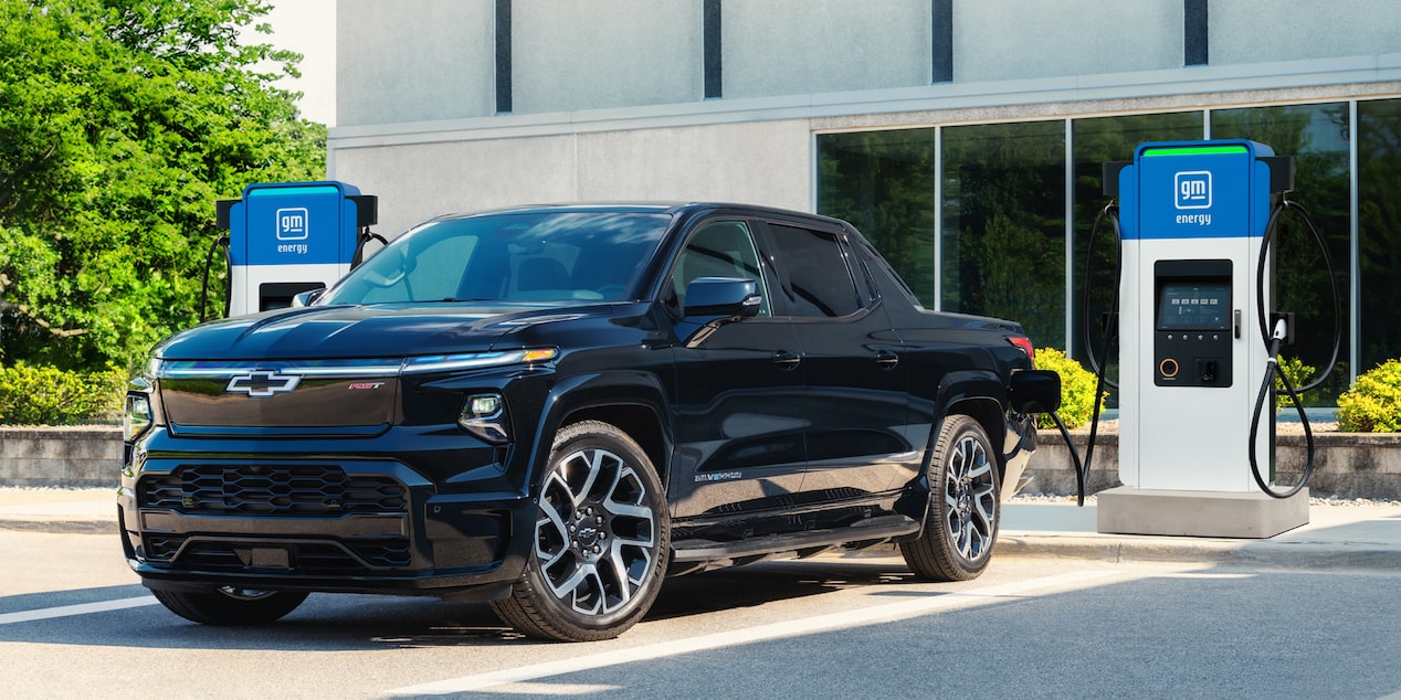 A black 2025 Silverado EV plugged into a charger