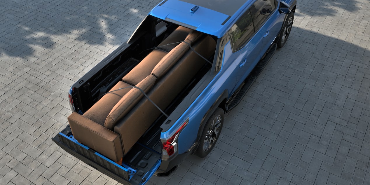2025 Chevy Silverado EV with a Couch in the Pickup Bed