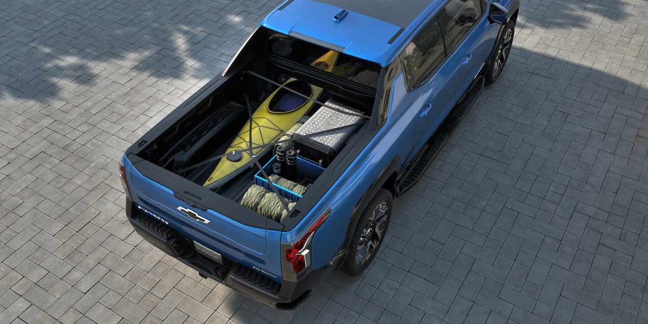 2025 Chevy Silverado EV with a Kayak and Camping Equipment in the Pickup Bed