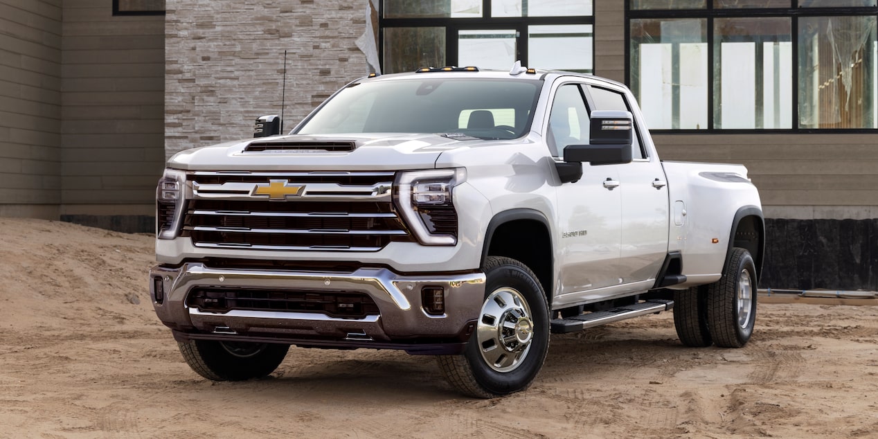 Three Quarters View of a White Chevy Silverado HD in Front of a House