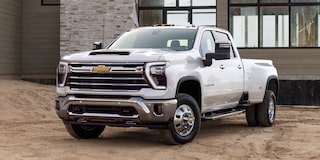 Three Quarters View of a White Chevy Silverado HD in Front of a House