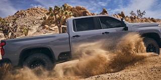 Side View of a 2025 Chevy Silverado HD Drifting on a Desert