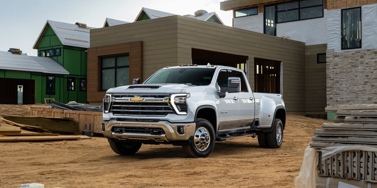 Three Quarters View of a White Chevy Silverado HD in Front of a House