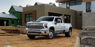 Three Quarters View of a White Chevy Silverado HD in Front of a House