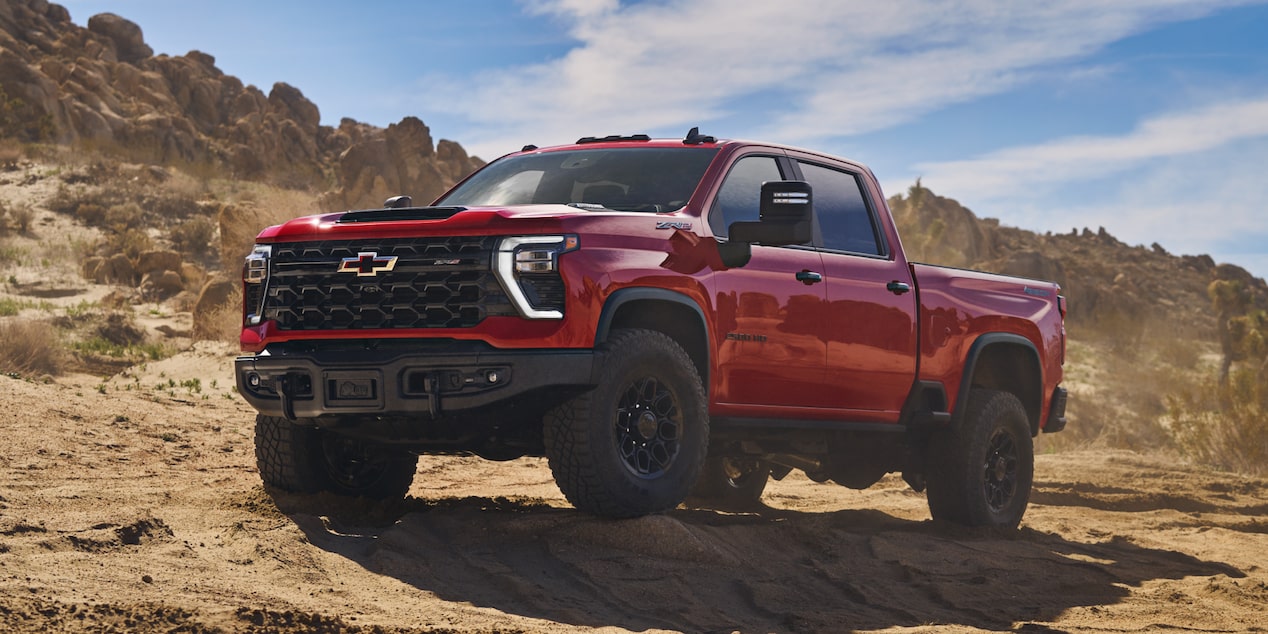 Three Quarters View of a Red 2025 Chevy Silverado HD in a Desert