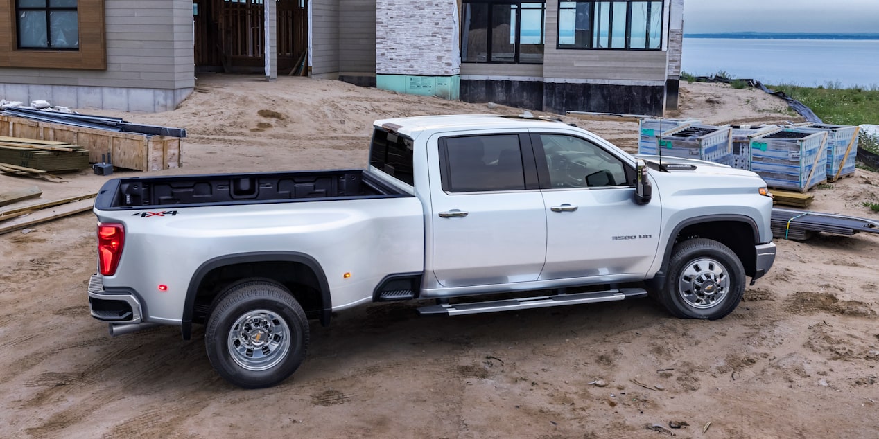 Side View of a White Chevy Silverado HD in front of a Body of Water