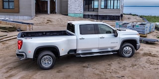 Side View of a White Chevy Silverado HD in front of a Body of Water