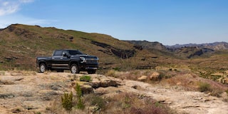 Far Side Three Quarters View of a Black 2025 Chevy Silverado HD on a Desert