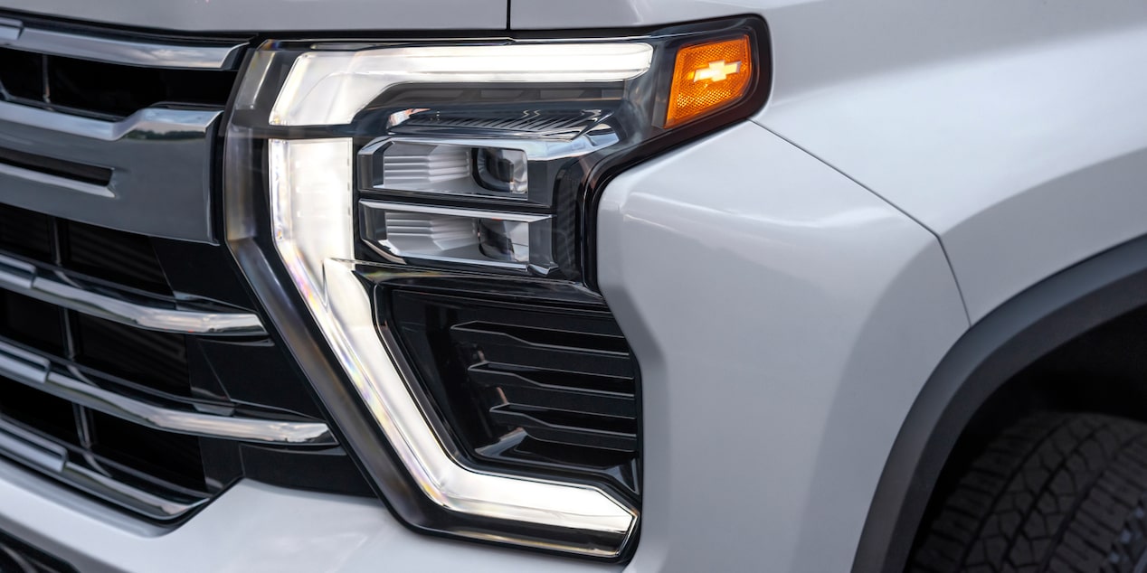 Close-up of the Headlight of a 2025 White Chevy Silverado HD