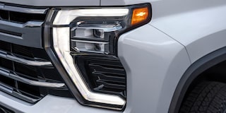 Close-up of the Headlight of a 2025 White Chevy Silverado HD