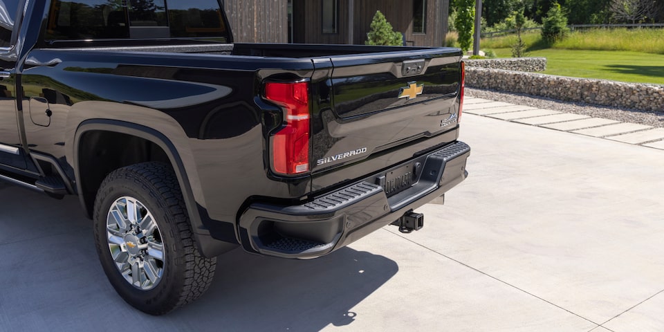 Three Quarters Rear View of a Chevy Silverado HD in Front of a House