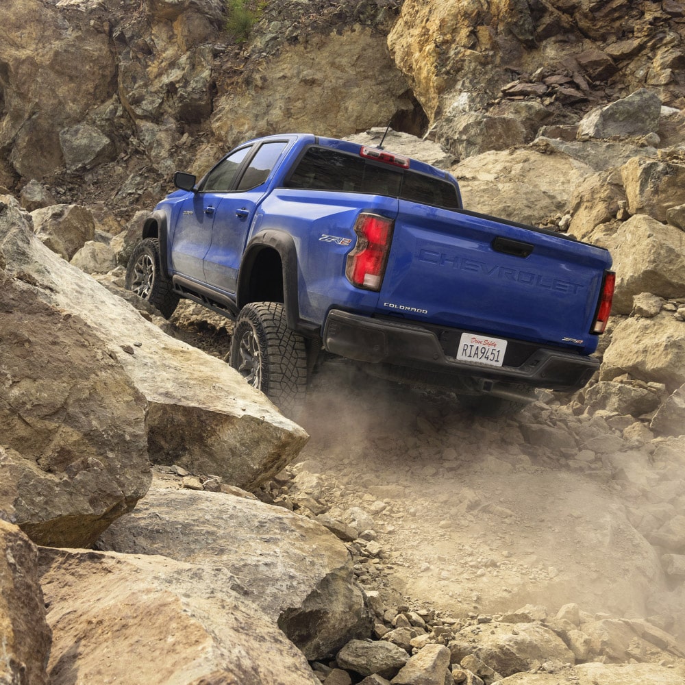  Overhead View of a 2025 Blue Chevy Colorado Going Upwards on a Rocky Plane