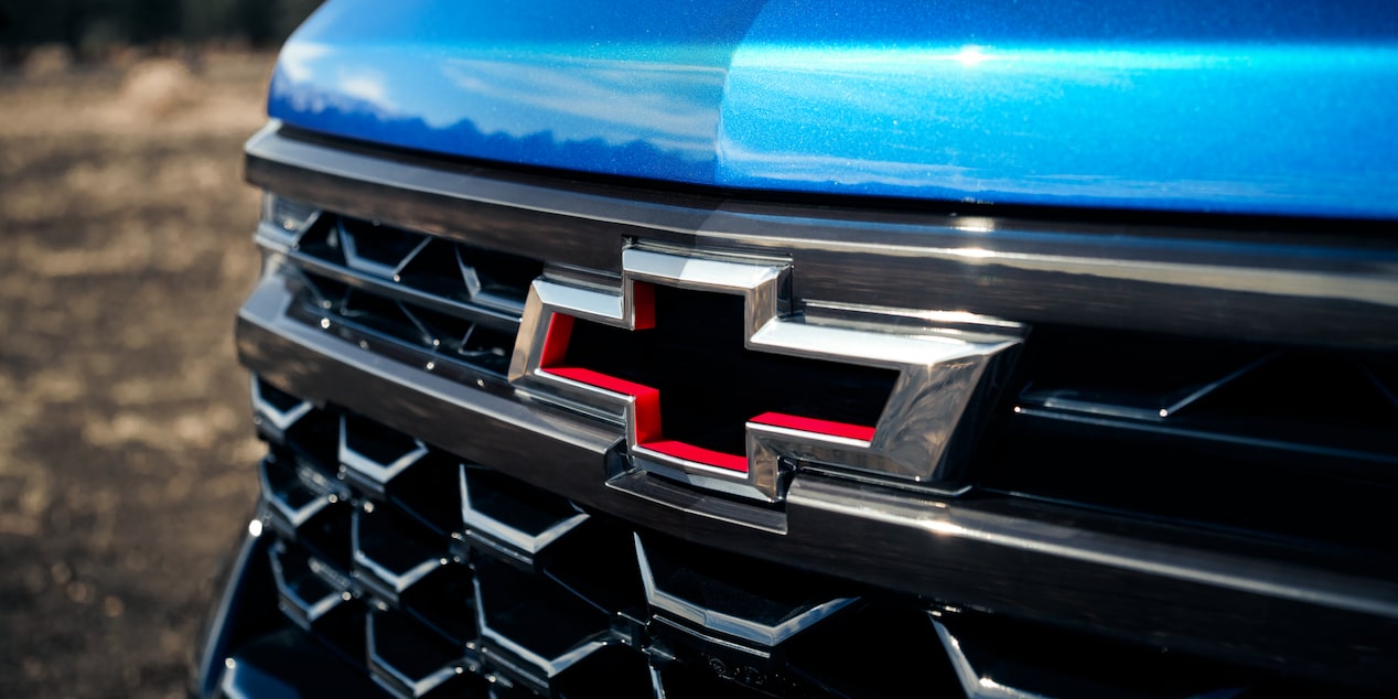 Close-up of the Chevy Logo on a Blue 2025 Chevy Silverado Pickup Truck