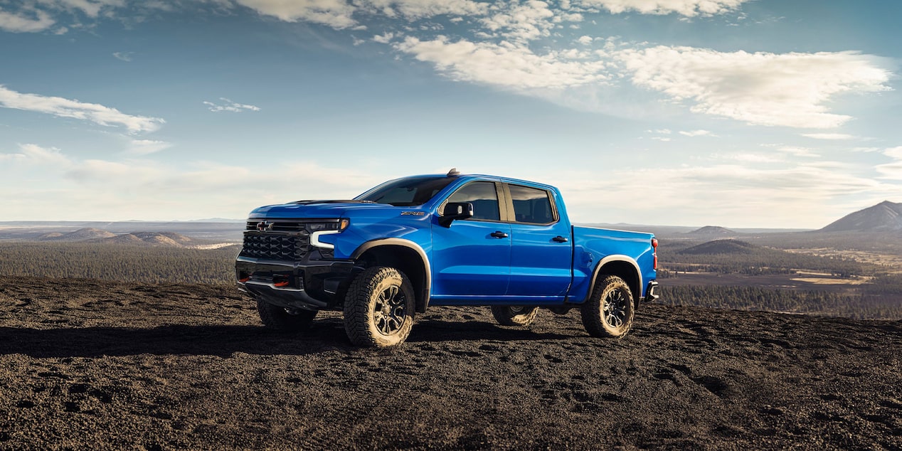 Three Quarters View of a Blue 2025 Chevy Silverado Pickup Truck on an Empty Plain