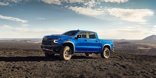 Three Quarters View of a Blue 2025 Chevy Silverado Pickup Truck on an Empty Plain