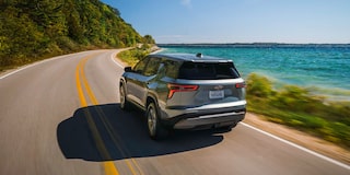 Rear End View of the 2026 Chevy Equinox Driving Along a Lake