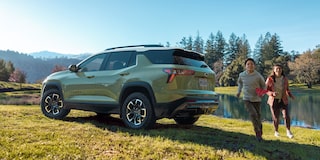 Kids Running Around a Parked 2026 Chevy Equinox Near the Woods