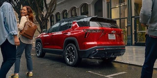People Walking Toward Their Parked 2026 Chevy Equinox in a Downtown