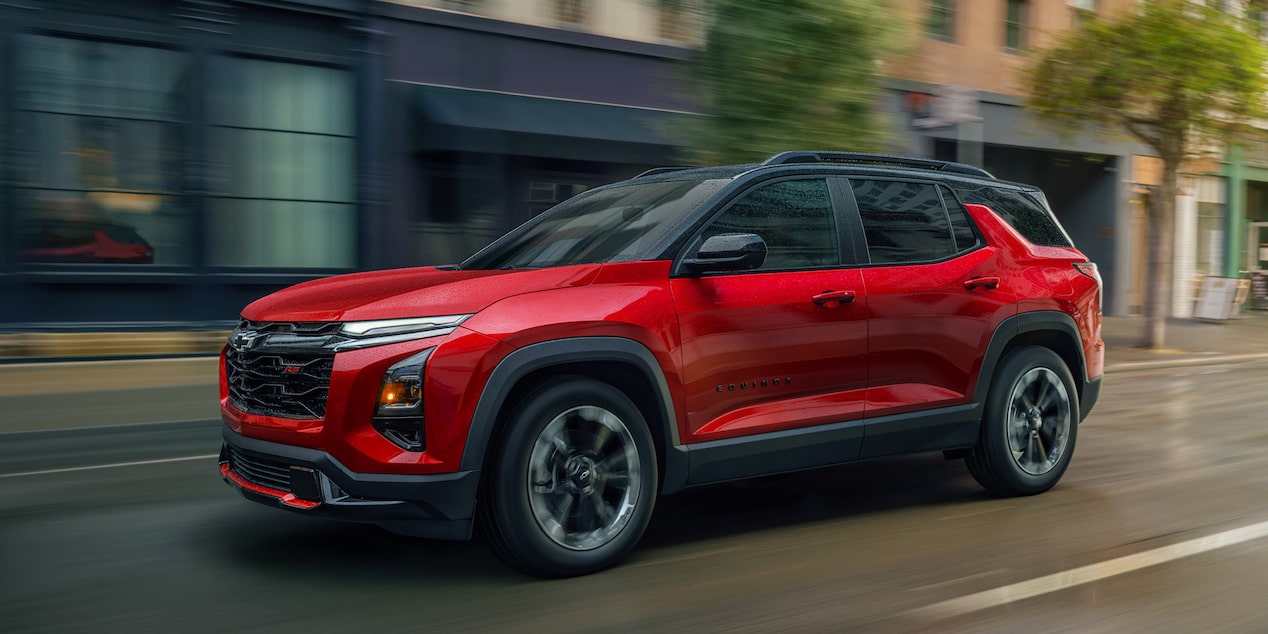2026 Chevy Equinox Side Exterior View Driving Through a Downtown