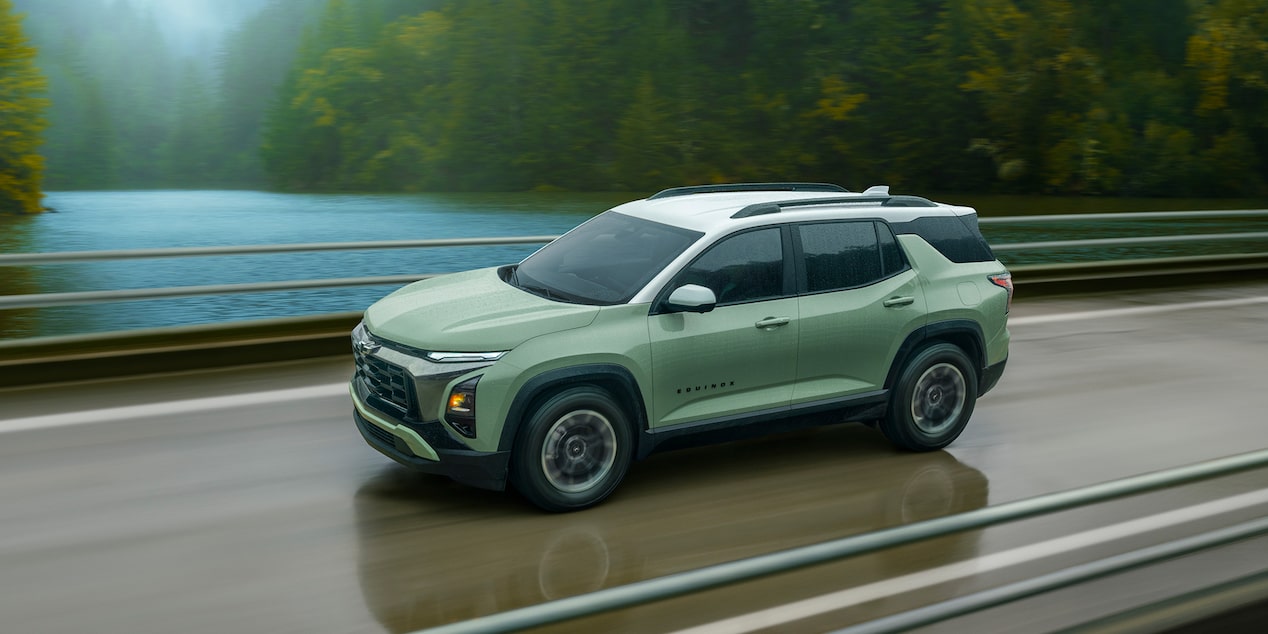 2026 Chevy Equinox Driving on a Bridge Over a River in the Forest
