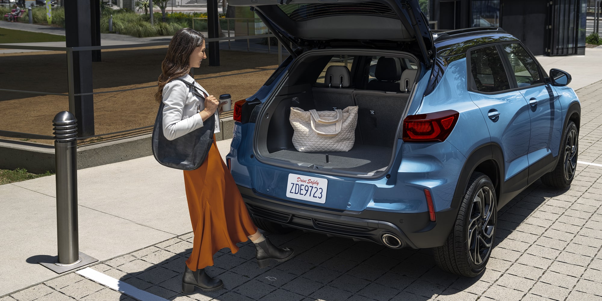 A Woman Loading Her Bag in the Trunk of the 2026 Chevy Trailblazer