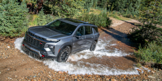 2026 Chevy Traverse Driving Through a Puddle in the Woods