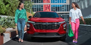 Two Women Walking Away from Their Parked 2026 Chevy Trax at a Mall