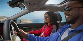 A Happy Couple Driving Their 2026 Chevy Trax