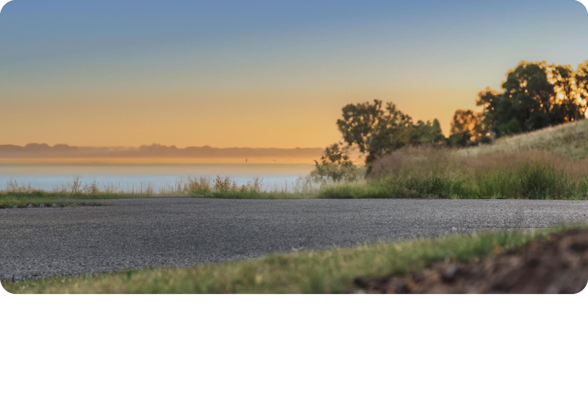 A Hazy Lake Shore During Sunset