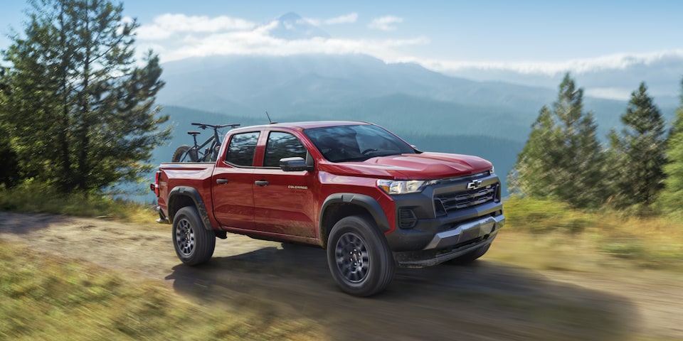 2026 Chevrolet Colorado Trail Boss on a dirt road with mountain bikes in the bed