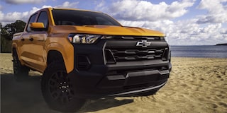 Three Quarters View of a Yellow 2026 Chevy Colorado on a Beach on a Sunny Day