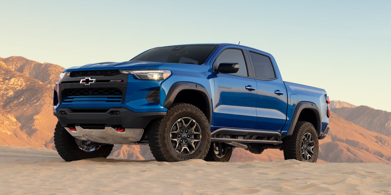 Low Angle Three Quarters View of a 2026 Blue Chevy Colorado on a Desert