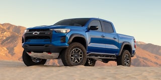 Low Angle Three Quarters View of a 2026 Blue Chevy Colorado on a Desert