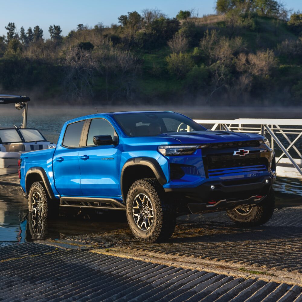 Three Quarters View of a 2026 Chevy Colorado Pickup Truck Pulling a Speed Boat to Shore