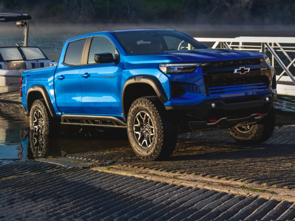 Three Quarters View of a 2026 Chevy Colorado Pickup Truck Pulling a Speed Boat to Shore