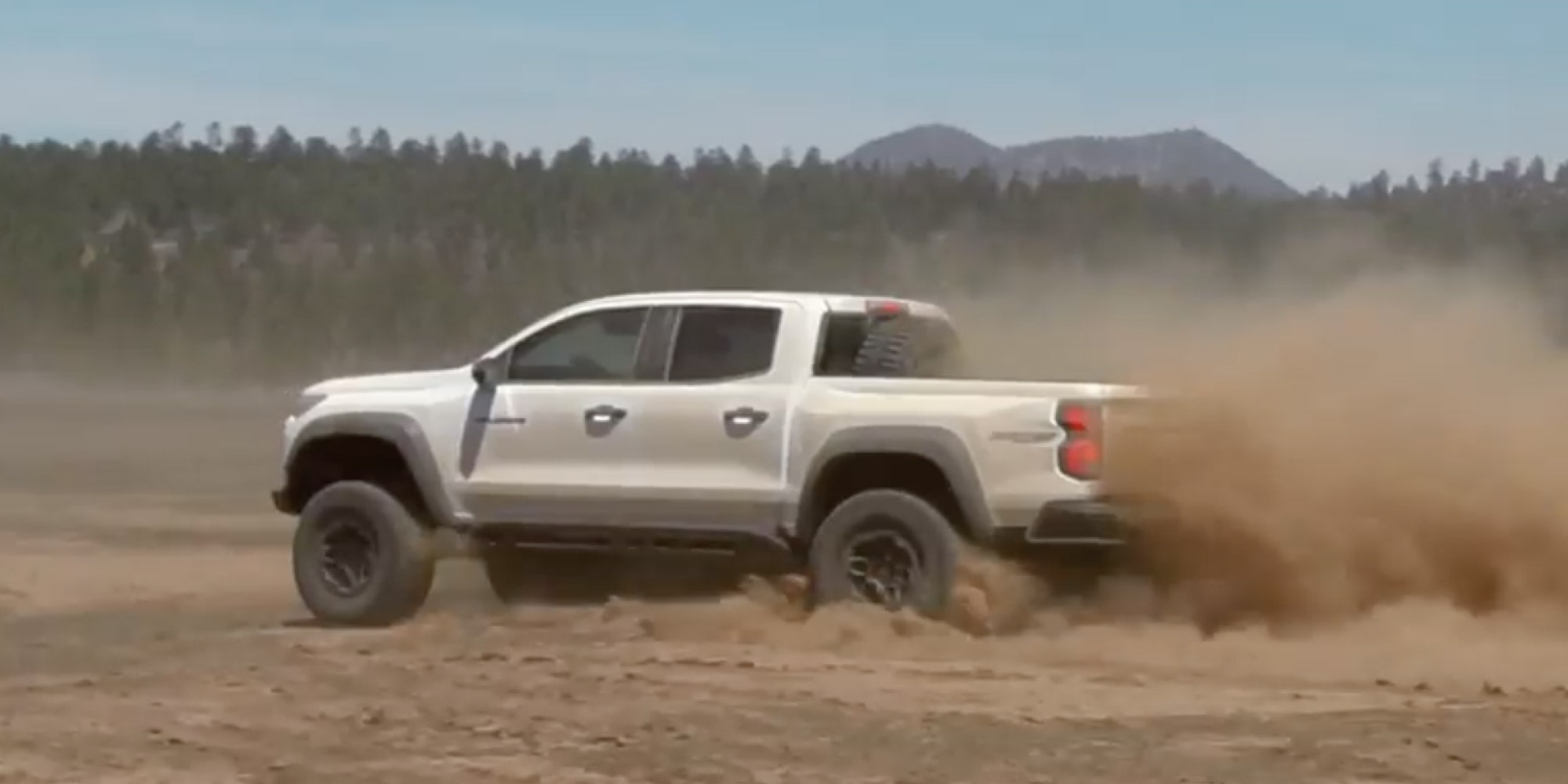 A Video Thumbnail of a Three Quarters View of a White 2026 Chevy Colorado Driving in a Desert