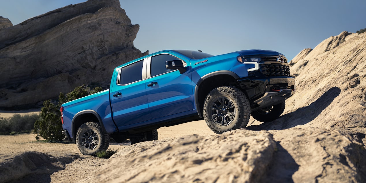 2026 Chevrolet Silverado LD parked on a rocky terrain on a sunny day.