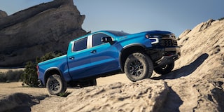 2026 Chevrolet Silverado LD parked on a rocky terrain on a sunny day.