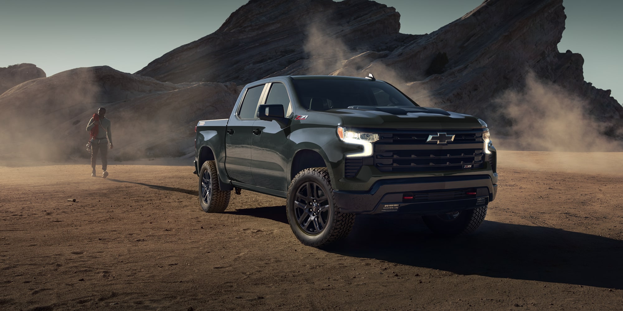 2026 Chevrolet Silverado LD Crew Cab LT driving on a dusty environment.