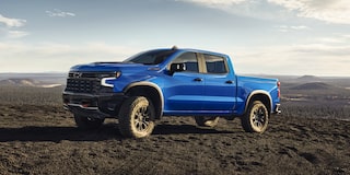 Side view of the 2026 Chevrolet Silverado LD Crew Cab ZR2 parked alone on a dirt terrain.