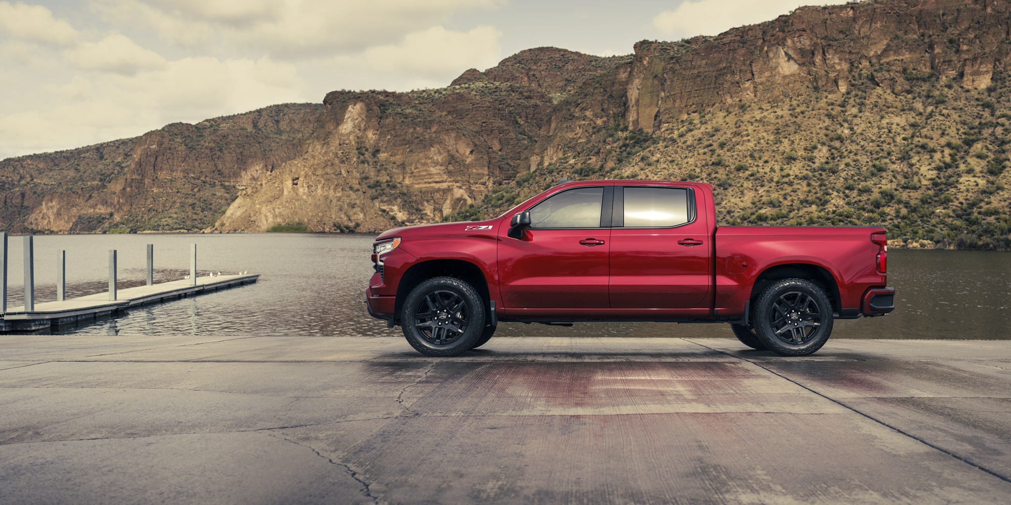 Side view of the 2026 Chevrolet Silverado LD Crew Cab RST parked by the docks.