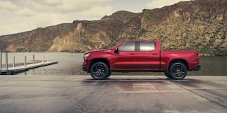 Side view of the 2026 Chevrolet Silverado LD Crew Cab RST parked by the docks.