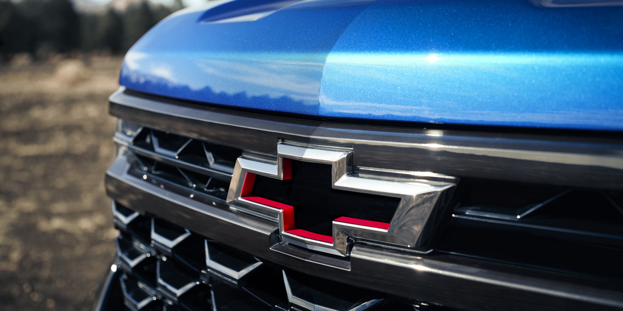 Close up view of the Chevrolet logo on the front grille of the 2026 Chevrolet Silverado LD Crew Cab ZR2.