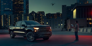2026 Chevrolet Silverado LD Crew Cab parked outdoors at night.