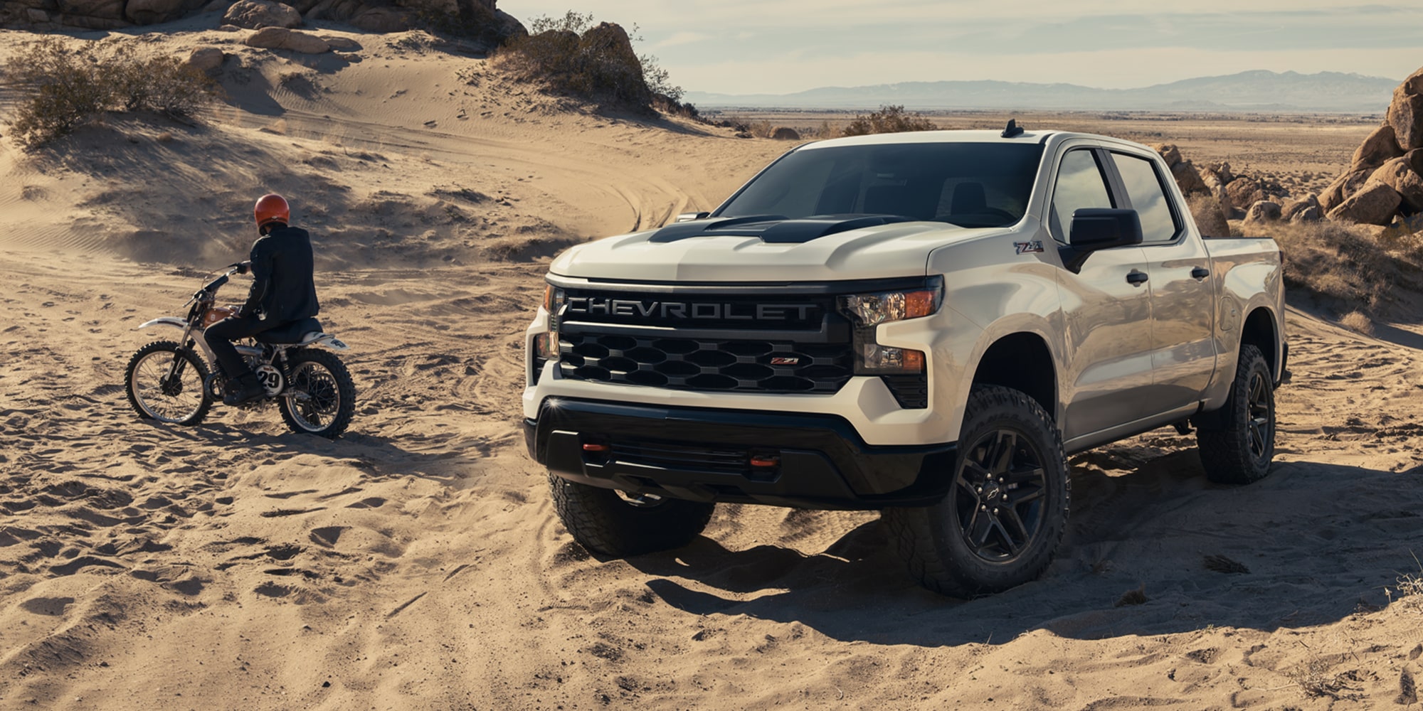 2026 Chevrolet Silverado LD Trail Boss parked on a sandy environment.