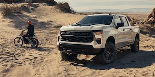 2026 Chevrolet Silverado LD Trail Boss parked on a sandy environment.
