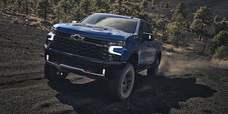 2026 Chevrolet Silverado LD Crew Cab ZR2 driving on a dirt terrain.