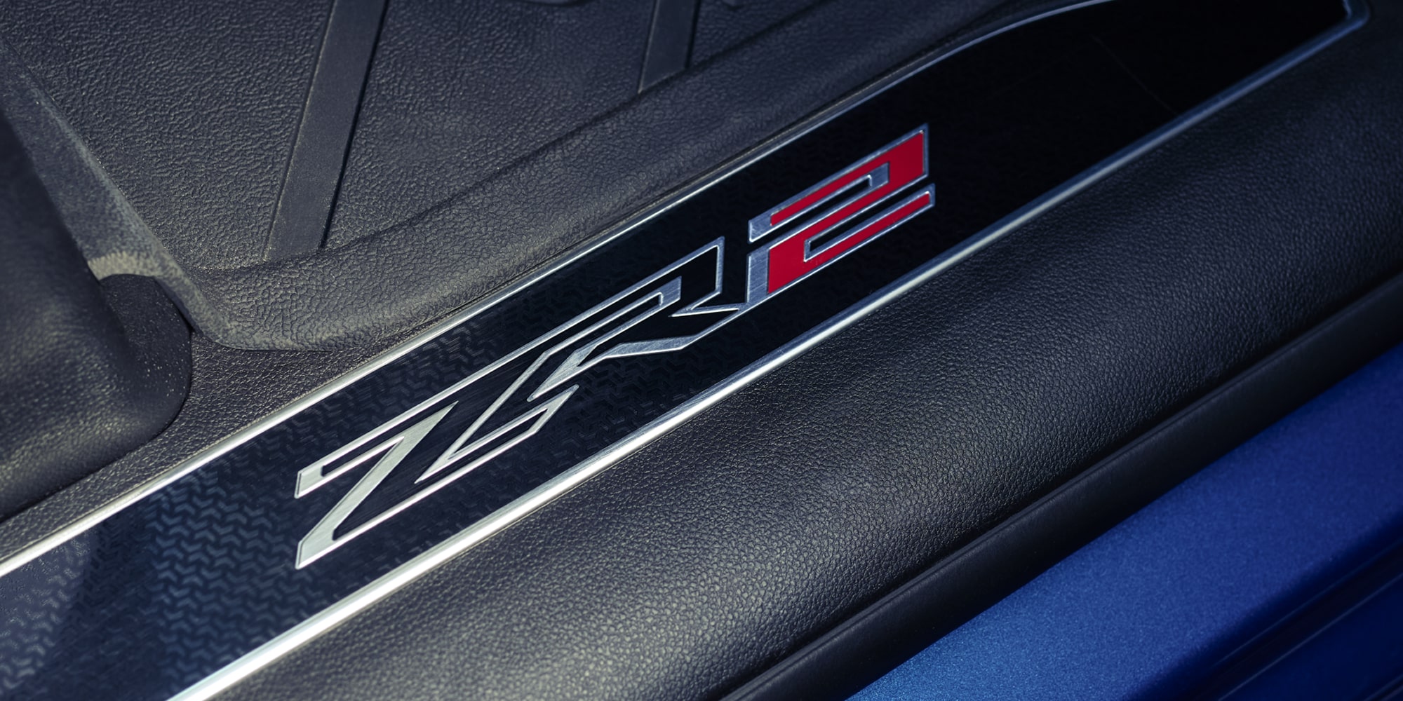 Close up view of the ZR2 logo etched on the sill plate of the 2026 Chevrolet Silverado LD Crew Cab ZR2.