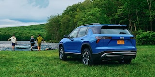 2026 Chevrolet Colorado Trail Boss Midnight Edition shown in black, featured in a rural setting in a 3/4 front passenger-side view while off-roading.